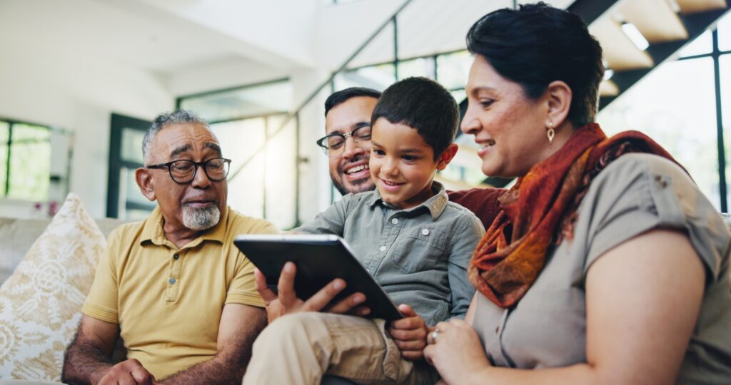 Big family, love and tablet on sofa for internet, search or streaming cartoon while bonding on home